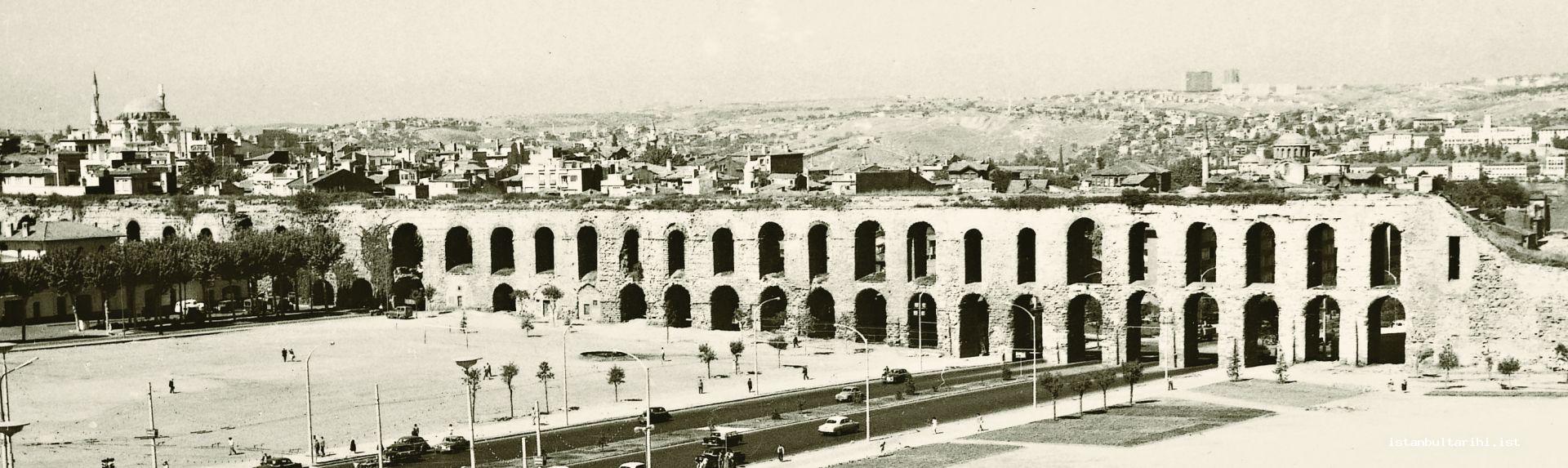 2- The view of Valens Aqueduct and Fatih district from the side of the building of Istanbul Metropolitan Municipality. Fatih Mosque is seen on the left side.The cone on one of its minarets is broken down.