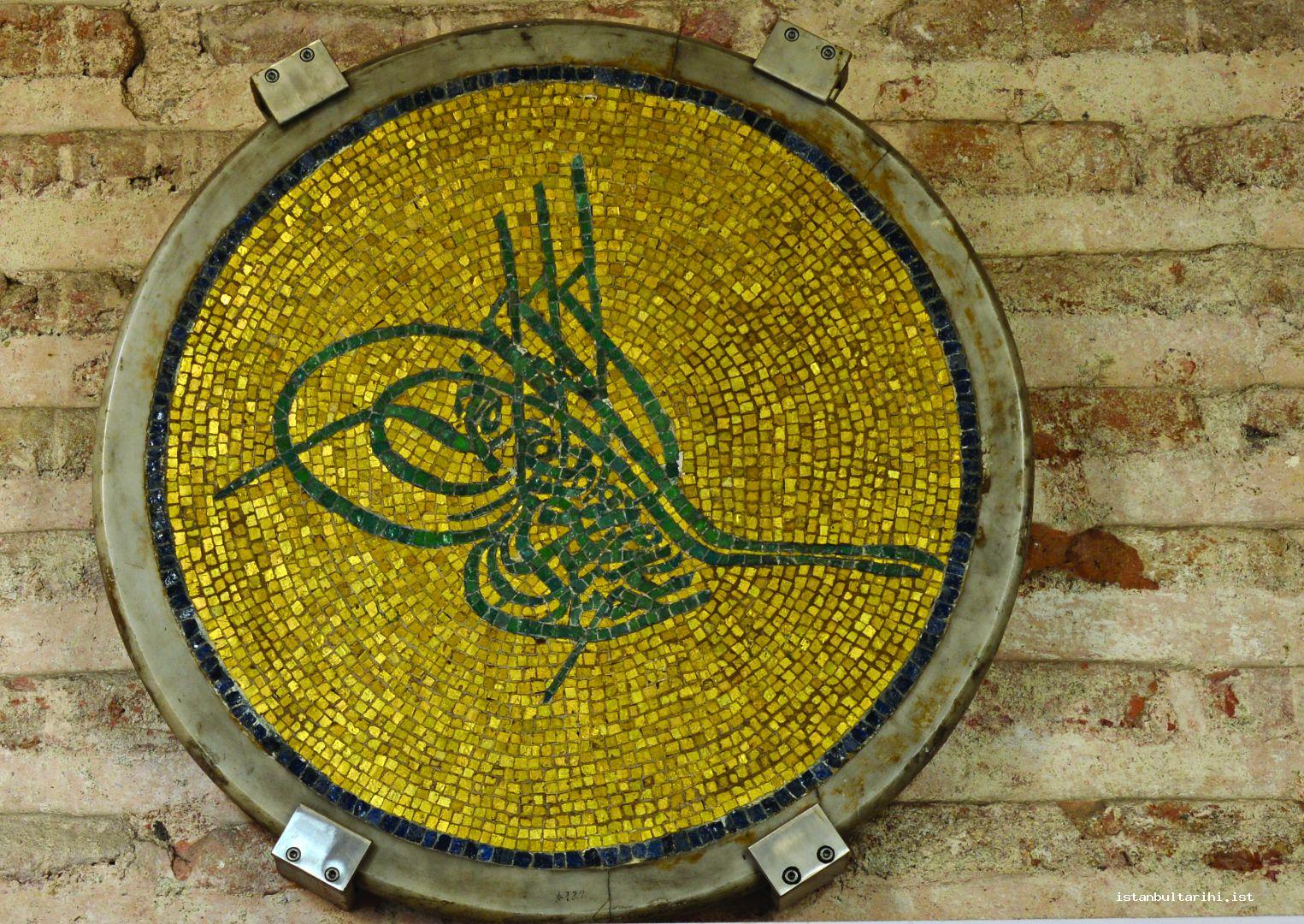9- Dış narteks ana giriş kapısının sağındaki duv arda sergilenen Sultan Abdülmecid'in tuğrası. Tuğra Fossati kardeşlerin Ayasofya onarımı sırasında duvarlardan dökülen orjinal altın aldızlımozaik parçalarından İtalyan usta N.Lanzoni tarafından yapılmıştır