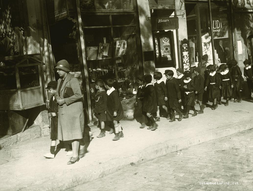 2- A group of elementary school students parade for some occasion in Eminönü under the supervision of their teacher (Istanbul Metropolitan Municipality, Kültür A.Ş.)    